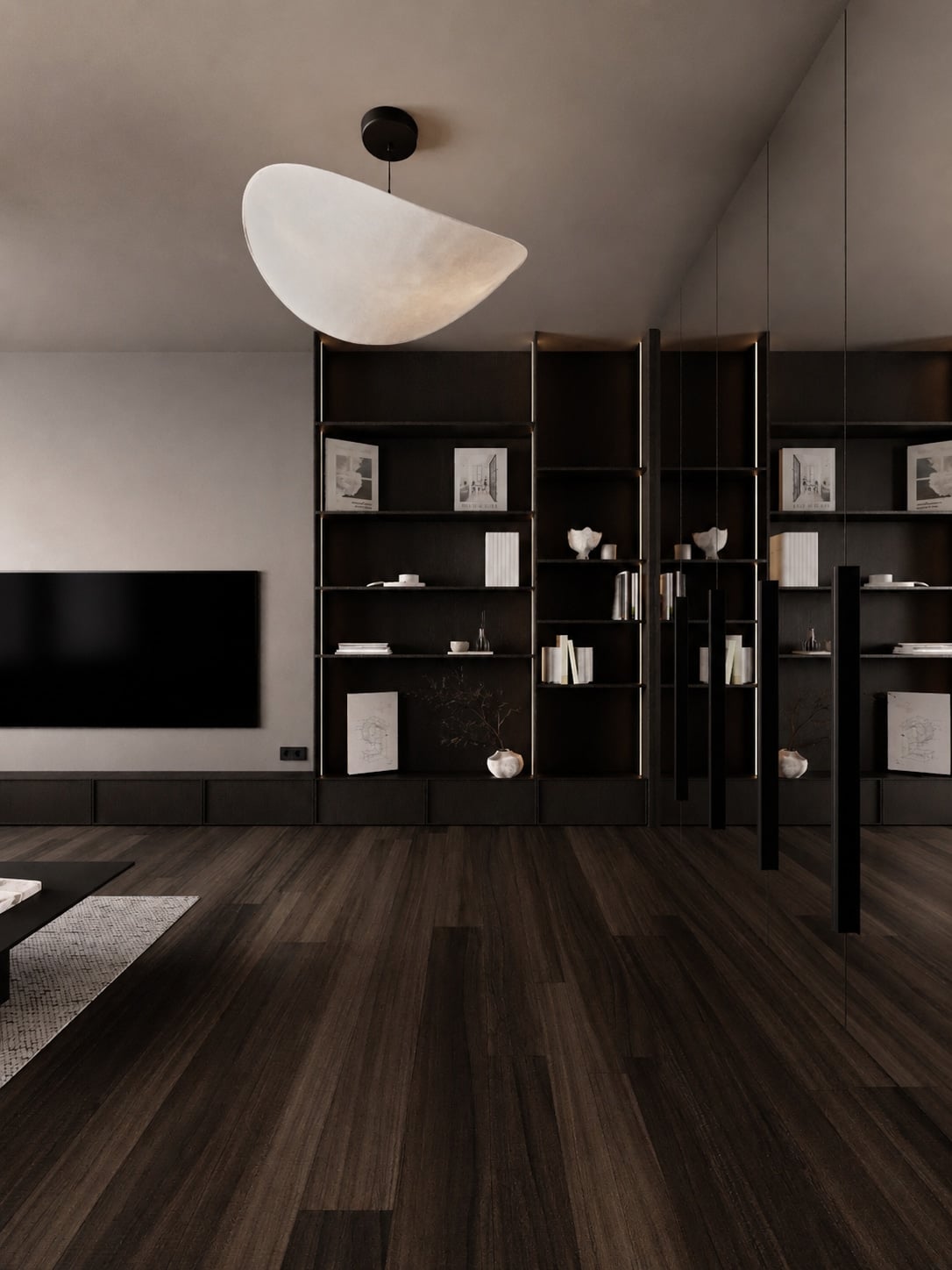 Open display shelving in dark timber beneath a sculptural white pendant light, holding books and ceramics.