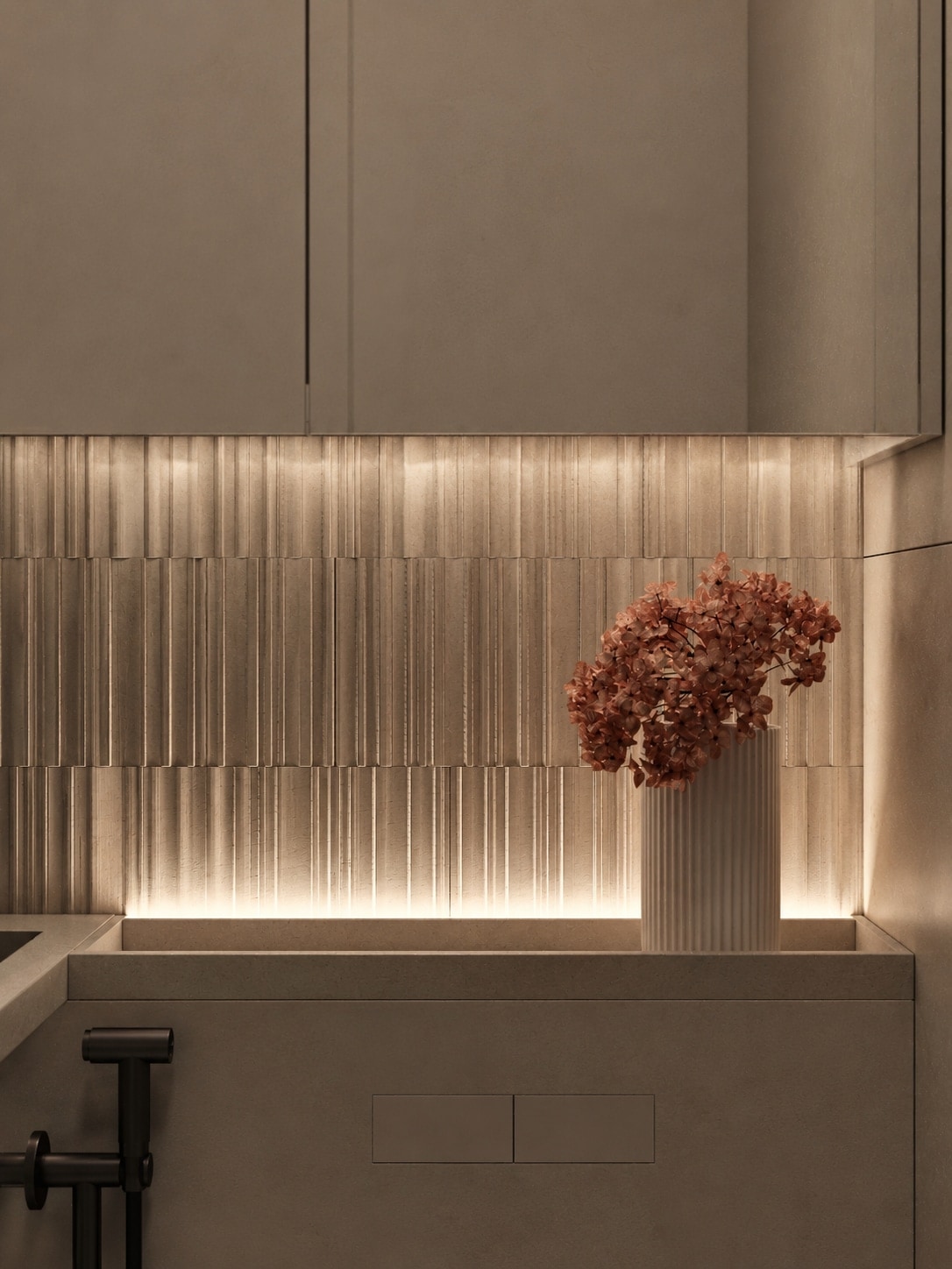 A backlit fluted stone wall with a dried flower arrangement set into the vanity counter.