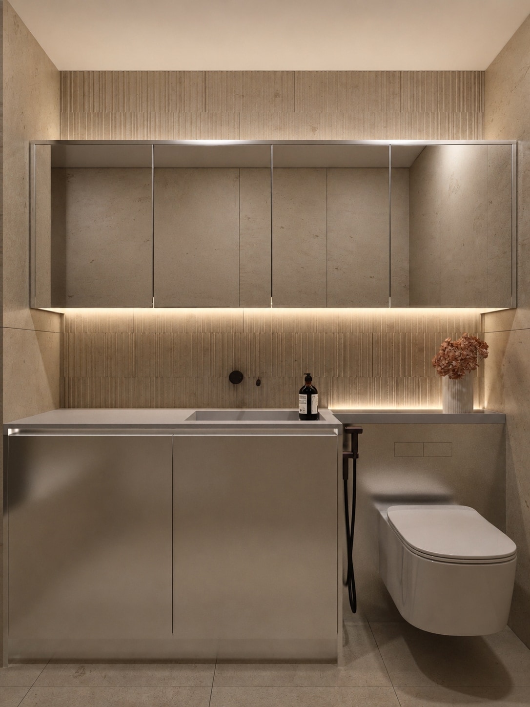 A stone-lined bathroom vanity with an illuminated mirror cabinet, a wall-hung WC and a floating stone-clad basin unit.