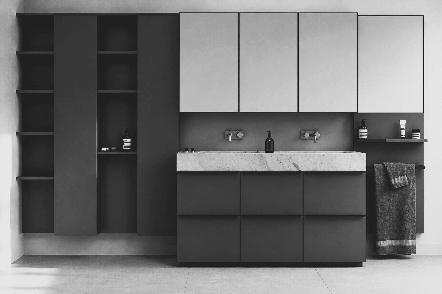 A full elevation of a charcoal bathroom vanity wall with open shelving, mirrored cabinets and a double stone trough basin.