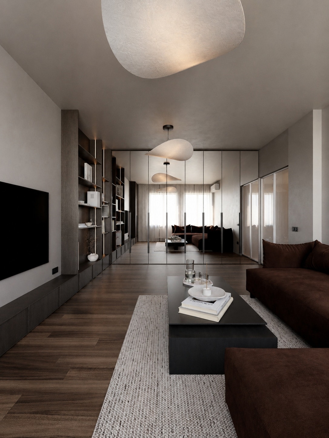 A long view down a living room, past a media wall and open shelving toward glazed doors at the far end.