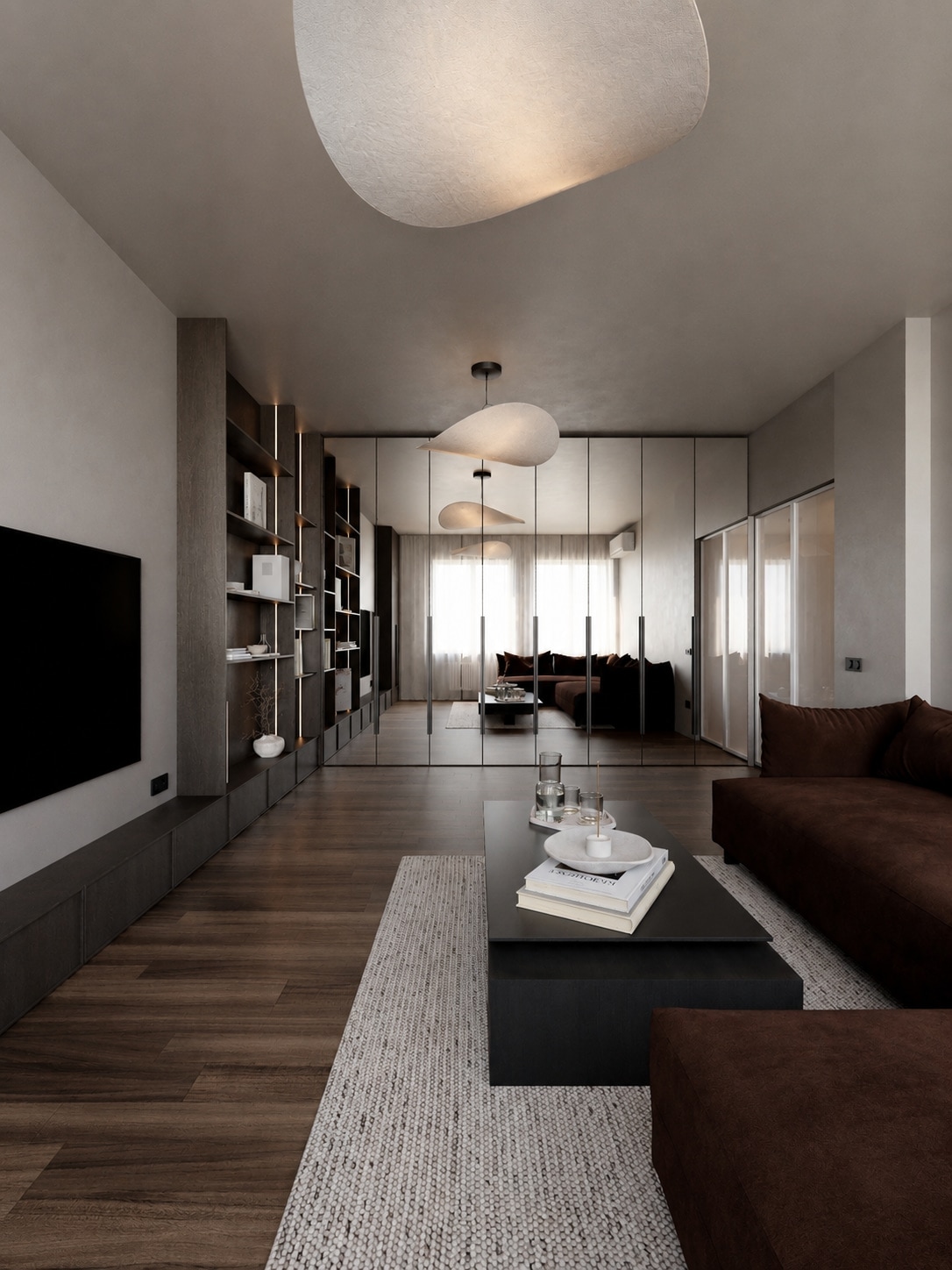 A long view down a living room, past a media wall and open shelving toward glazed doors at the far end.