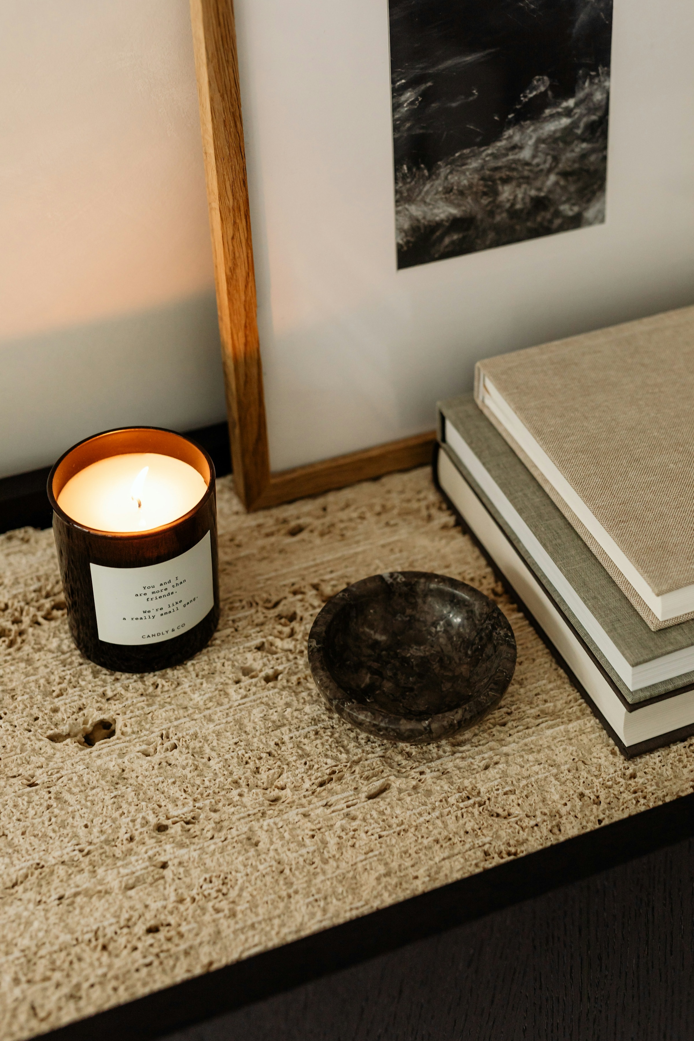 Close study of stacked stone edges beside a lit candle, showing the cut face of the material.
